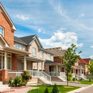 A picture of line of houses with a front yard garden
