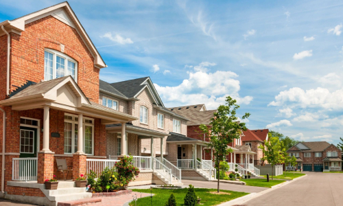 A picture of line of houses with a front yard garden